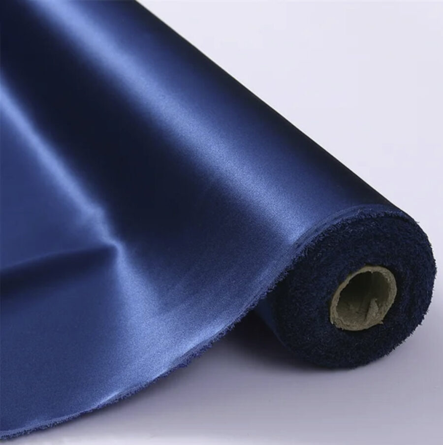 Silk charmeuse fabric on the bolt, navy blue